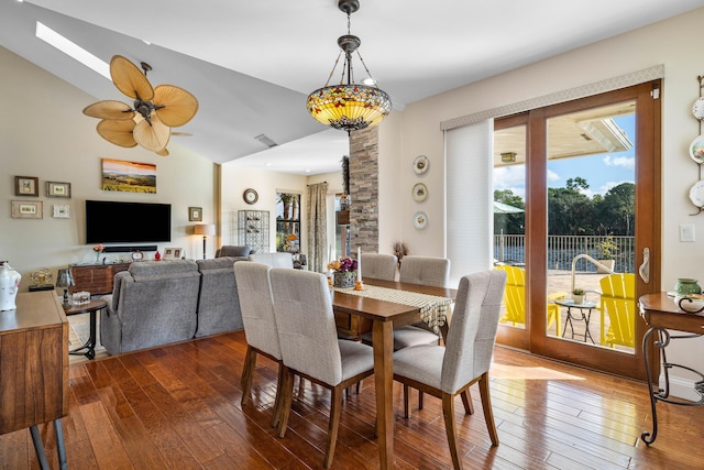 dining room with hardwood / wood-style floors, vaulted ceiling, and ceiling fan