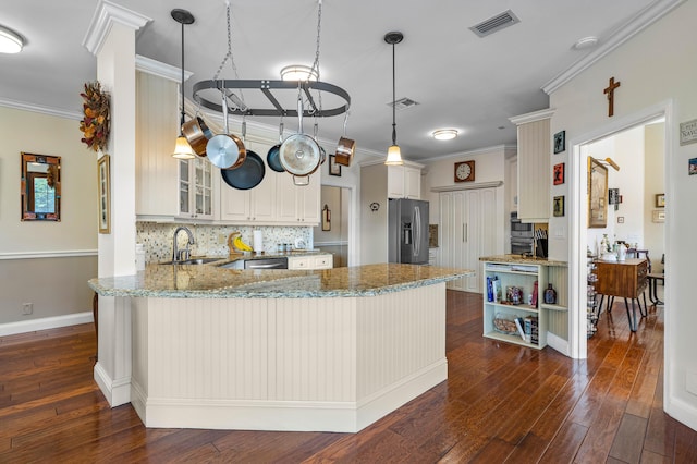 kitchen featuring stainless steel appliances, crown molding, pendant lighting, and kitchen peninsula