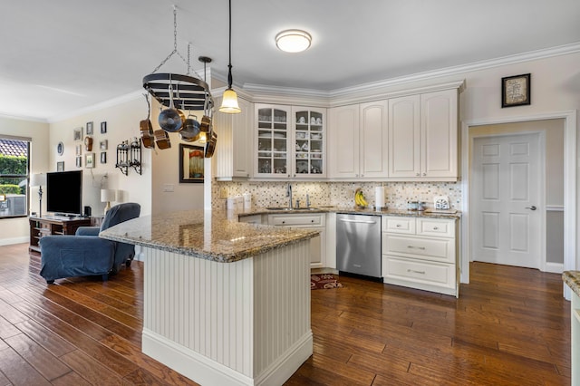 kitchen with decorative light fixtures, sink, dark hardwood / wood-style flooring, stainless steel dishwasher, and kitchen peninsula