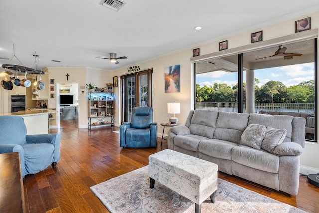 living room featuring ornamental molding, hardwood / wood-style floors, and ceiling fan