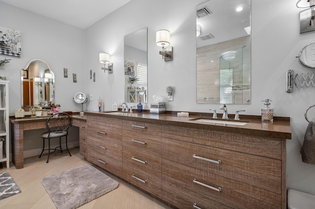 bathroom featuring tile patterned floors, vanity, and a shower with door