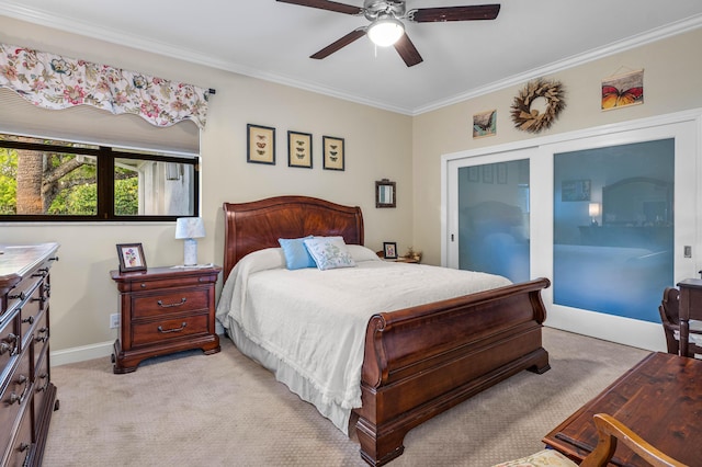 carpeted bedroom featuring crown molding and ceiling fan