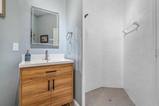 bathroom with vanity and tiled shower