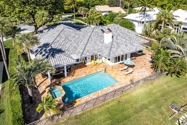 view of pool featuring a lawn and a patio