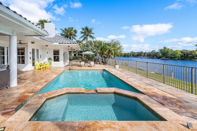 view of pool with a patio area, an in ground hot tub, ceiling fan, and a water view