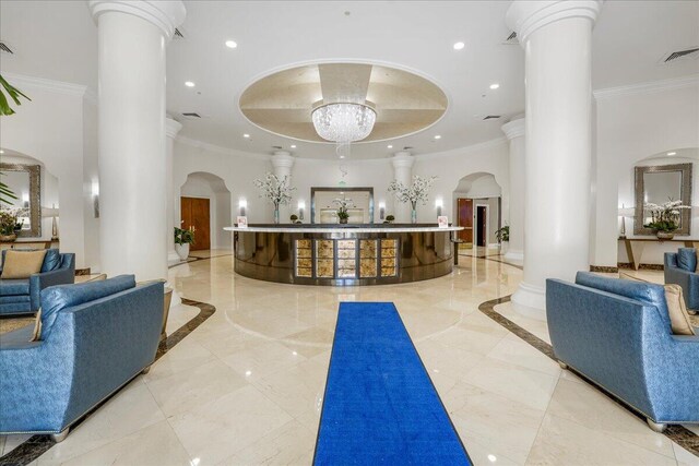 reception area with an inviting chandelier and ornate columns