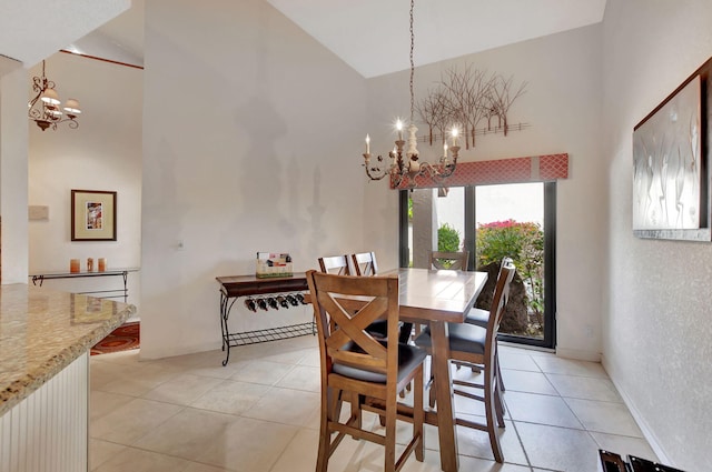 tiled dining area featuring a notable chandelier and a high ceiling