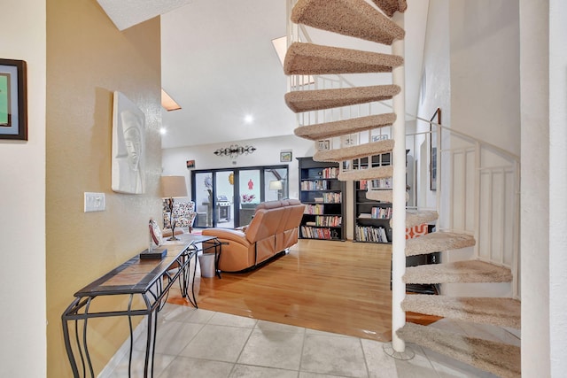 stairs featuring a towering ceiling and tile patterned floors