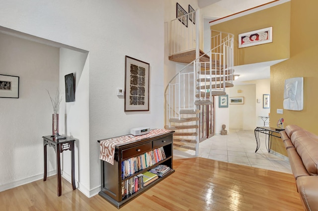 interior space featuring wood-type flooring and a high ceiling