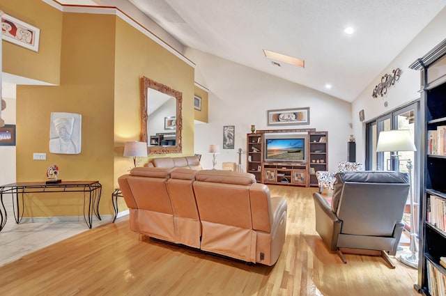 living room featuring high vaulted ceiling and light hardwood / wood-style flooring