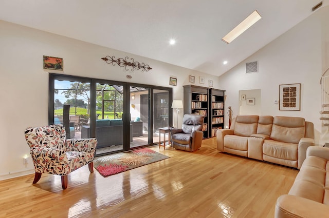 living room with wood-type flooring and high vaulted ceiling