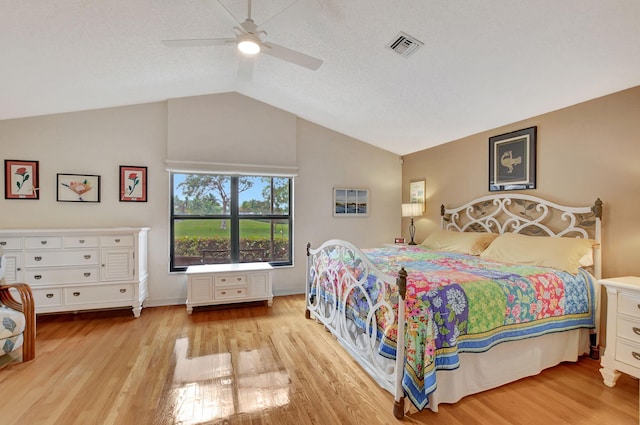 bedroom with vaulted ceiling, ceiling fan, and light hardwood / wood-style floors