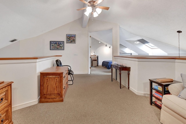 interior space with light carpet, vaulted ceiling, and ceiling fan