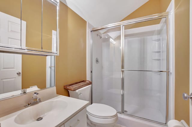 bathroom featuring walk in shower, vanity, toilet, and vaulted ceiling