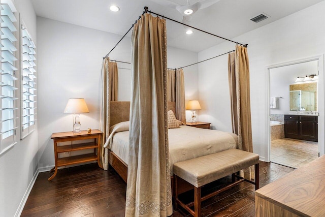 bedroom with ensuite bath and dark hardwood / wood-style flooring