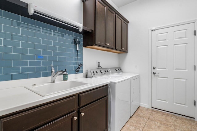 clothes washing area with cabinets, light tile patterned flooring, sink, and independent washer and dryer