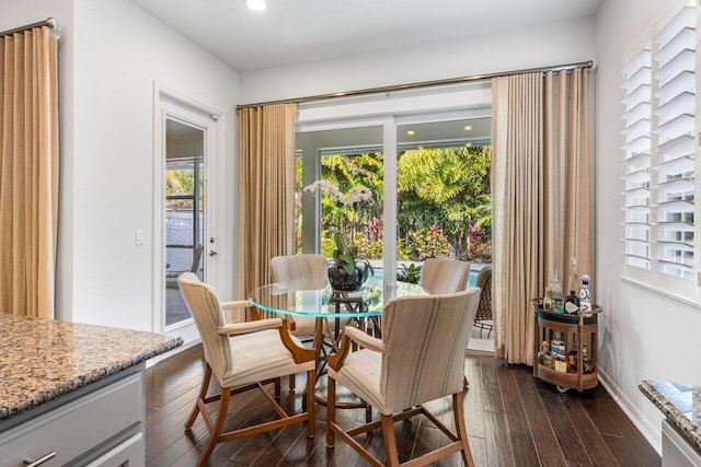 dining area featuring dark wood-type flooring