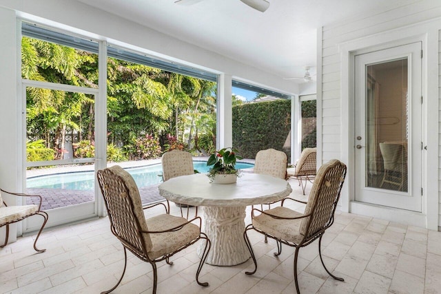 sunroom featuring ceiling fan