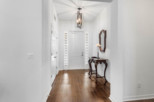 entryway featuring dark hardwood / wood-style flooring and a notable chandelier