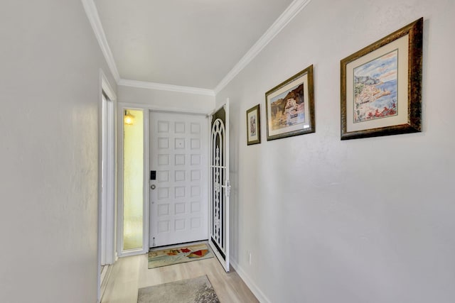 doorway to outside featuring crown molding and light hardwood / wood-style floors