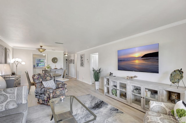 living room featuring crown molding and light hardwood / wood-style floors