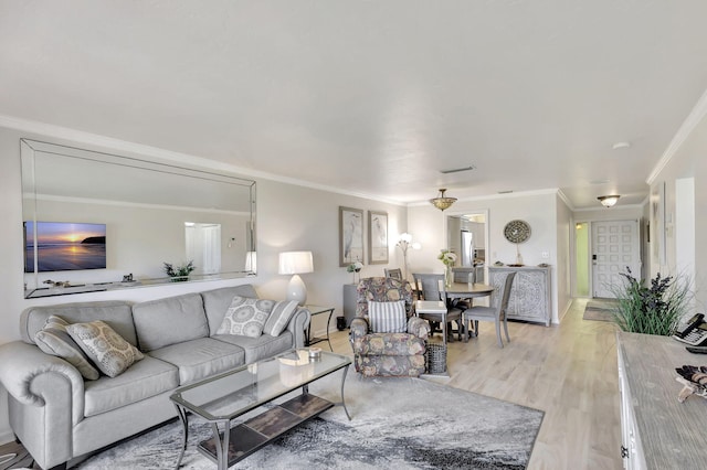 living room featuring ornamental molding and light hardwood / wood-style flooring