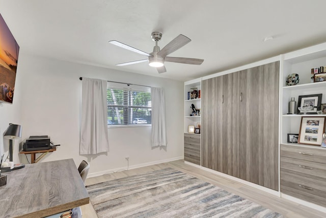 office space featuring ceiling fan and light wood-type flooring