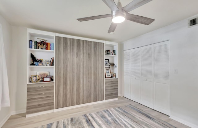 bedroom with a closet, ceiling fan, and light hardwood / wood-style flooring