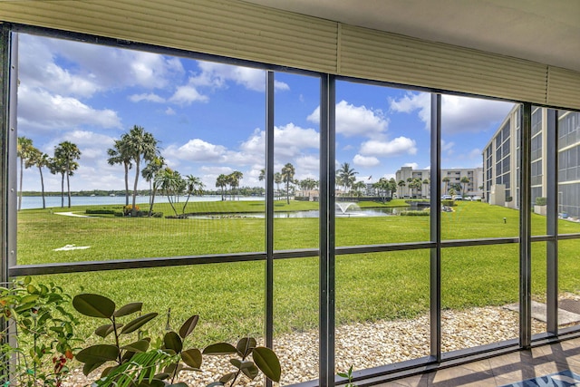 unfurnished sunroom with a water view