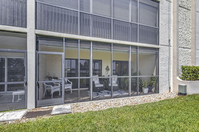 rear view of house featuring a sunroom