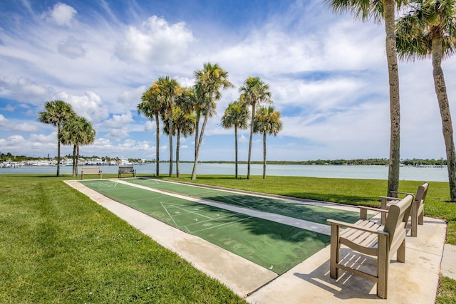 surrounding community with a yard and a water view