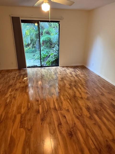 empty room featuring ceiling fan and hardwood / wood-style floors