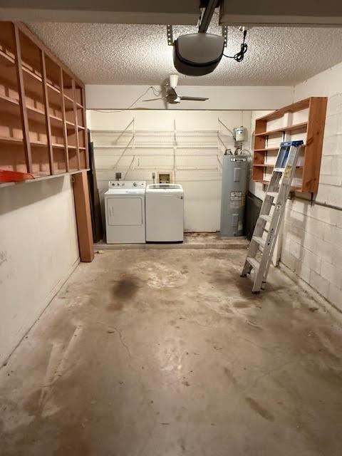 garage with water heater and separate washer and dryer