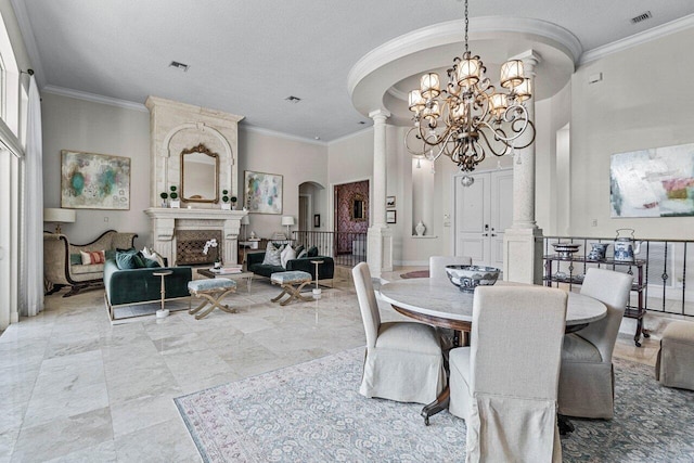 dining space featuring decorative columns, a fireplace, ornamental molding, a textured ceiling, and a chandelier