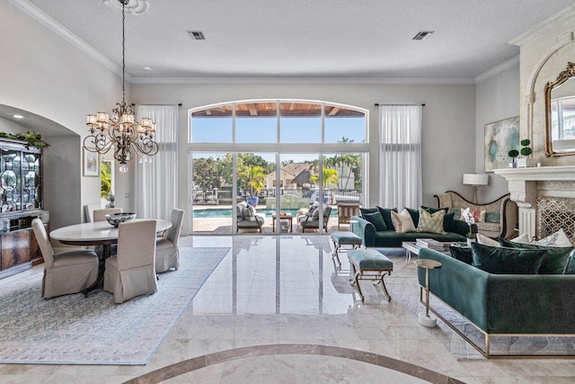 living room featuring an inviting chandelier, crown molding, and a textured ceiling