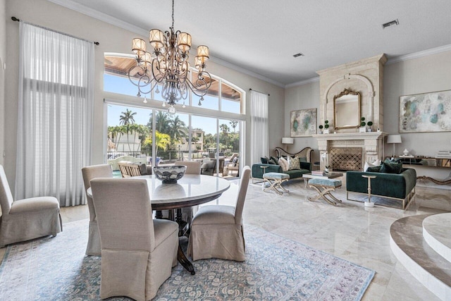 dining room featuring a notable chandelier, a fireplace, and ornamental molding