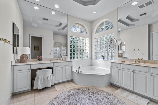 bathroom with separate shower and tub, tile patterned floors, vanity, and a raised ceiling