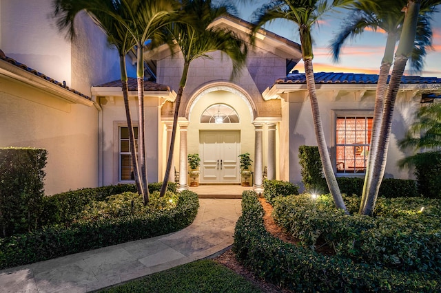 view of exterior entry at dusk