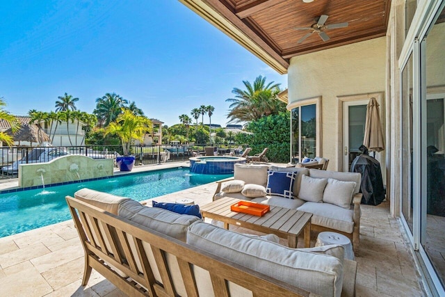 view of swimming pool with an in ground hot tub, pool water feature, outdoor lounge area, and a patio