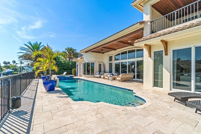 view of pool featuring a patio and an in ground hot tub