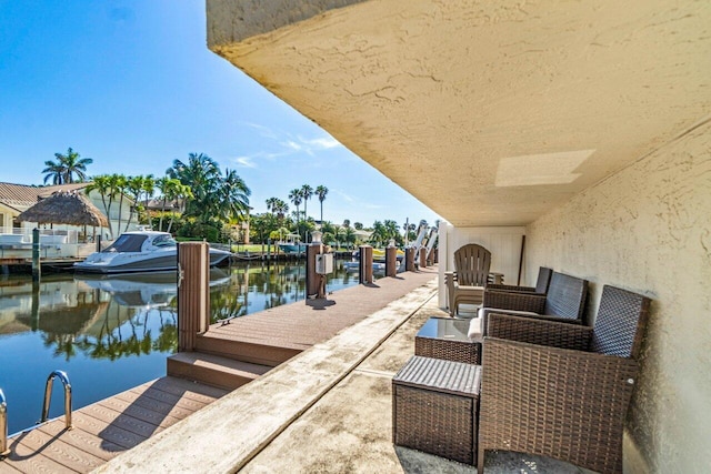 exterior space with a water view and a dock