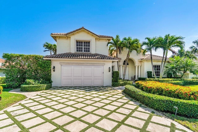 mediterranean / spanish house with a garage