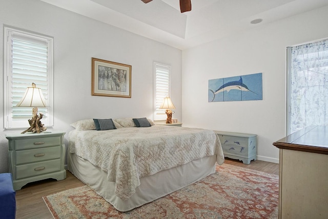 bedroom with ceiling fan and light hardwood / wood-style floors