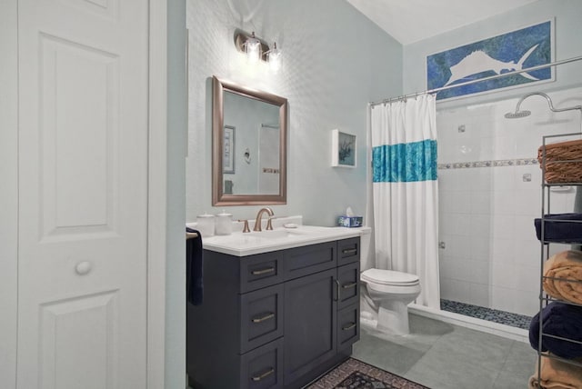 bathroom with vanity, tile patterned flooring, toilet, and walk in shower