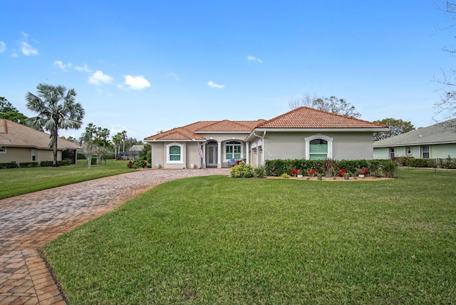 mediterranean / spanish-style home featuring a front yard