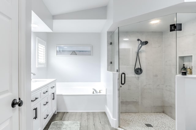 bathroom with vanity, wood-type flooring, and independent shower and bath