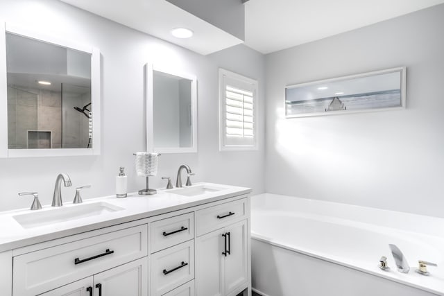 bathroom with vanity and independent shower and bath