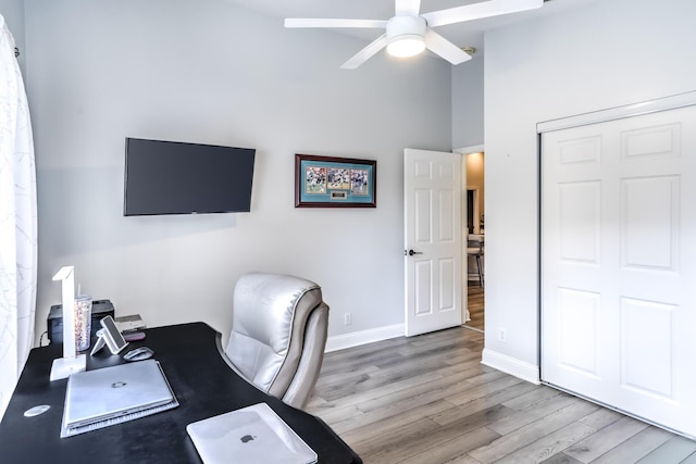 office with ceiling fan and light hardwood / wood-style floors