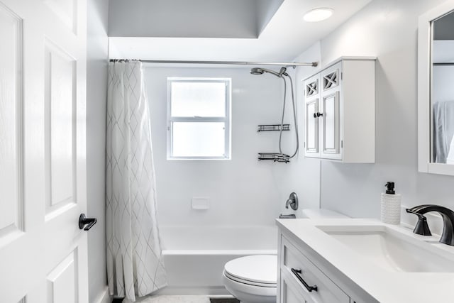 full bathroom with vanity, shower / tub combo with curtain, and toilet