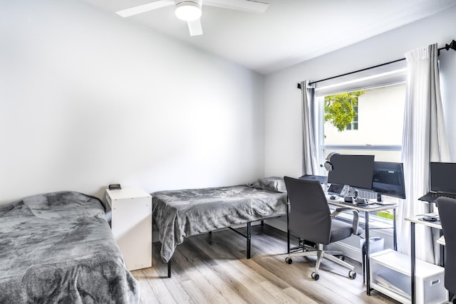 bedroom with ceiling fan and light hardwood / wood-style flooring